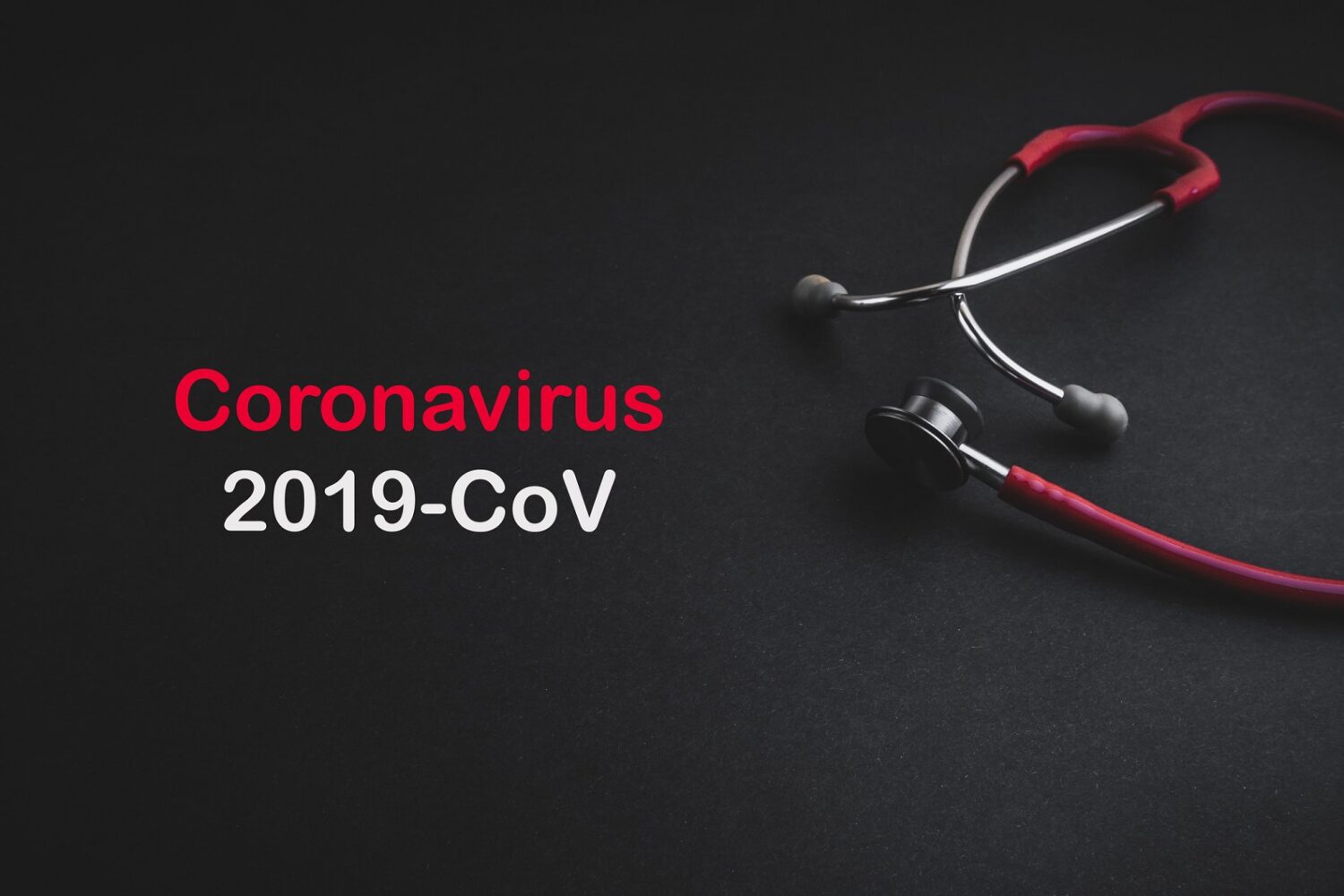 Stethoscope with words CORONA VIRUS 2019 COV on black background. Selective focus and crop fragment